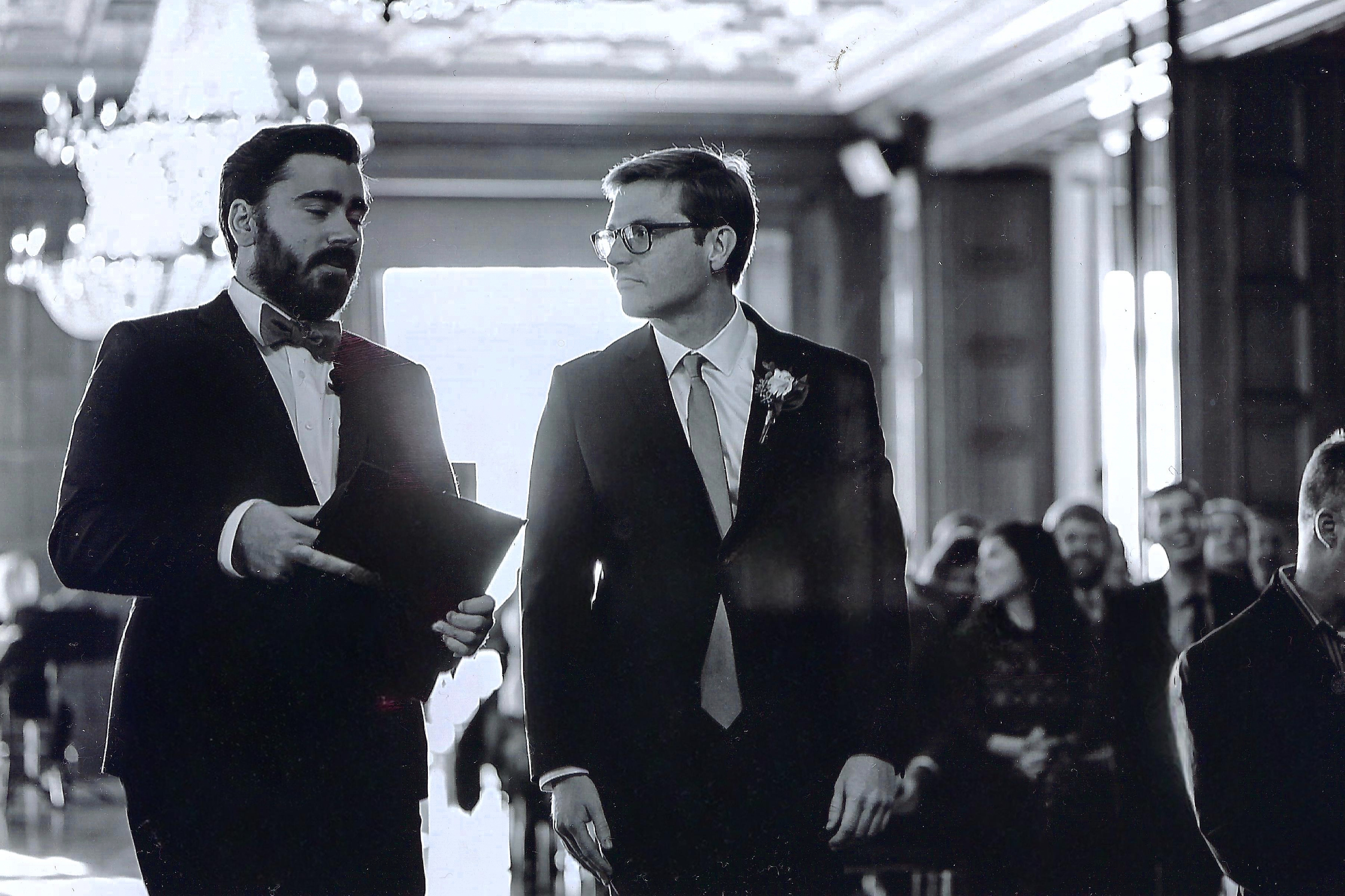 The officiant walking in with the groom just before the ceremony begins